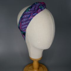A blue and purple bandana with an 80's look with aluminum wire. The bandana is wrapped around the head of a mannequin.