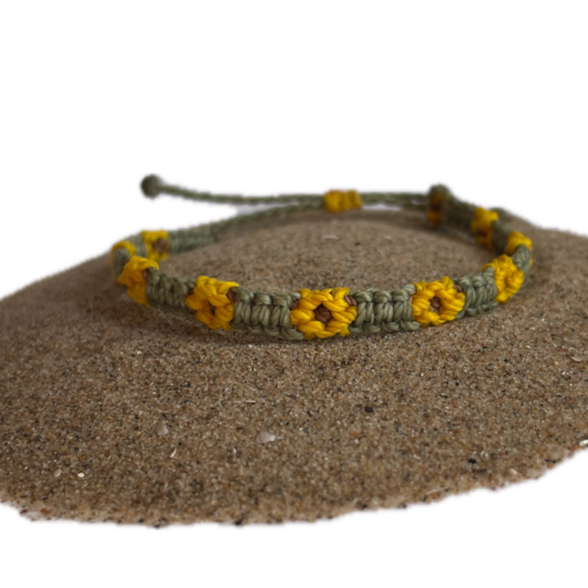 Knotted sunflower bracelet. The flower is yellow, the bracelet is green.